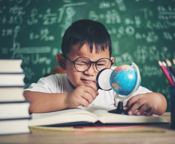 kid-observing-studying-educational-globe-model-classroom_1150-3832